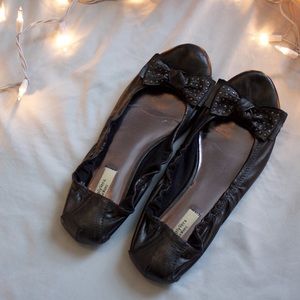 Gunmetal colored flats with studded bows